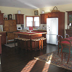 A full kitchen offers views of the property and overlooks the large dining and living rooms.